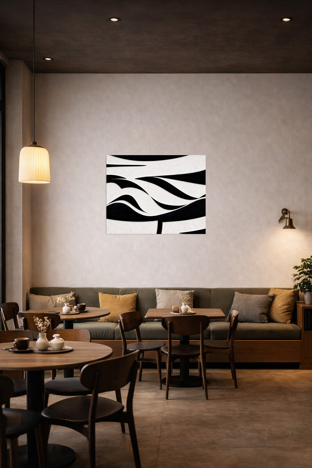 Modern abstract black and white wall art displayed in a stylish café interior