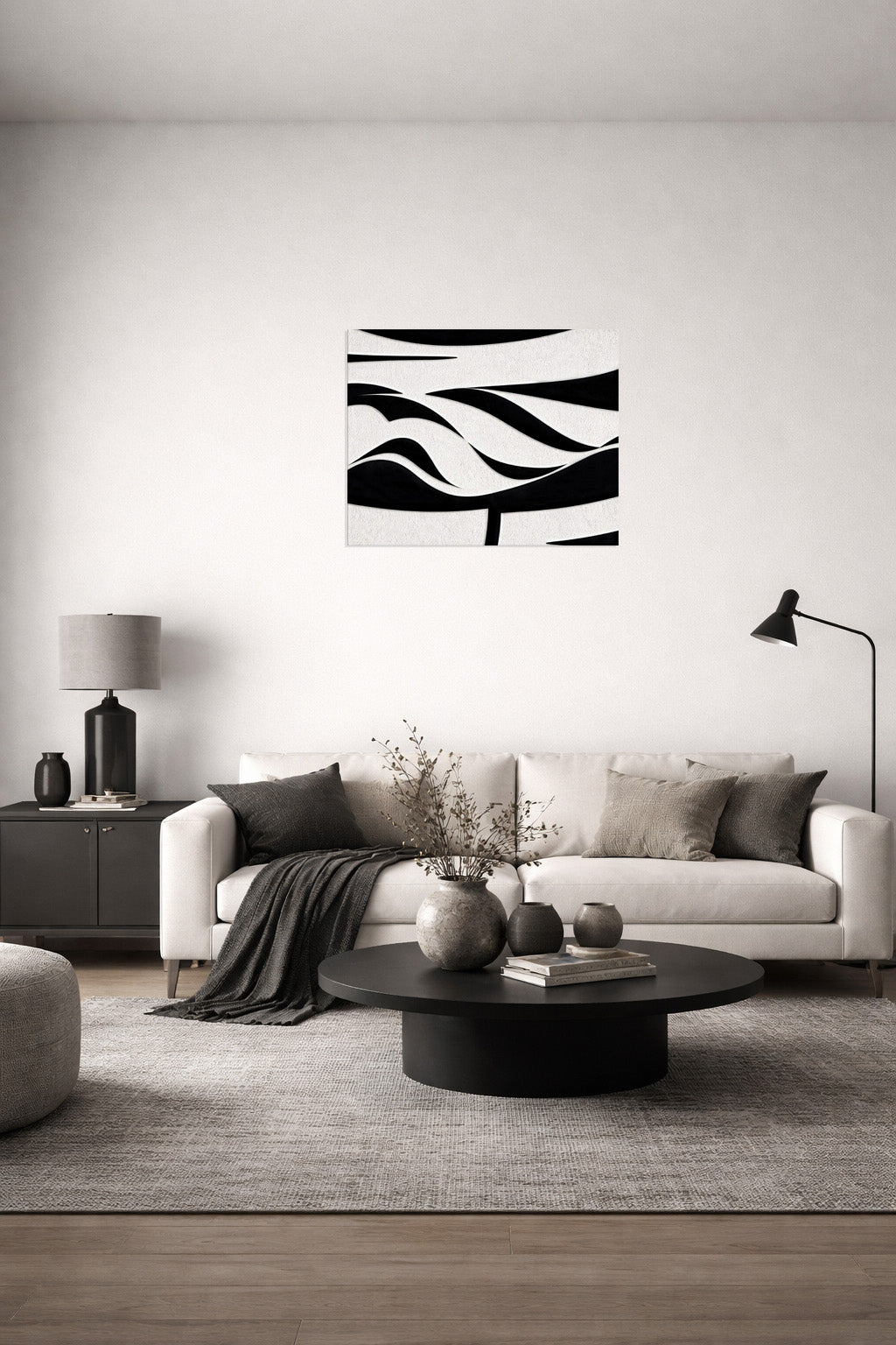 Modern abstract black and white wall art above a neutral sofa interior