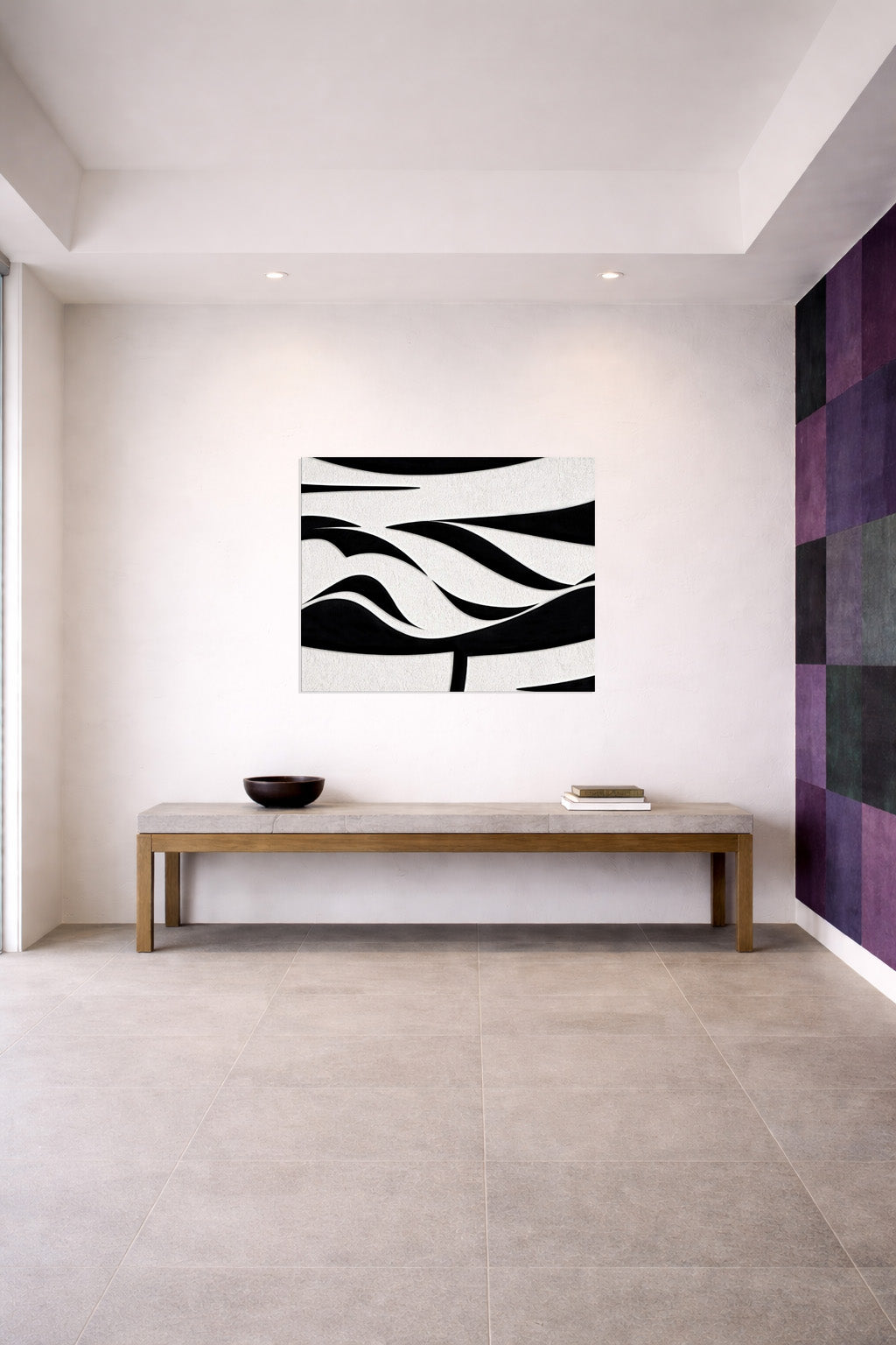 Black and white abstract wall art in a modern open interior setting
