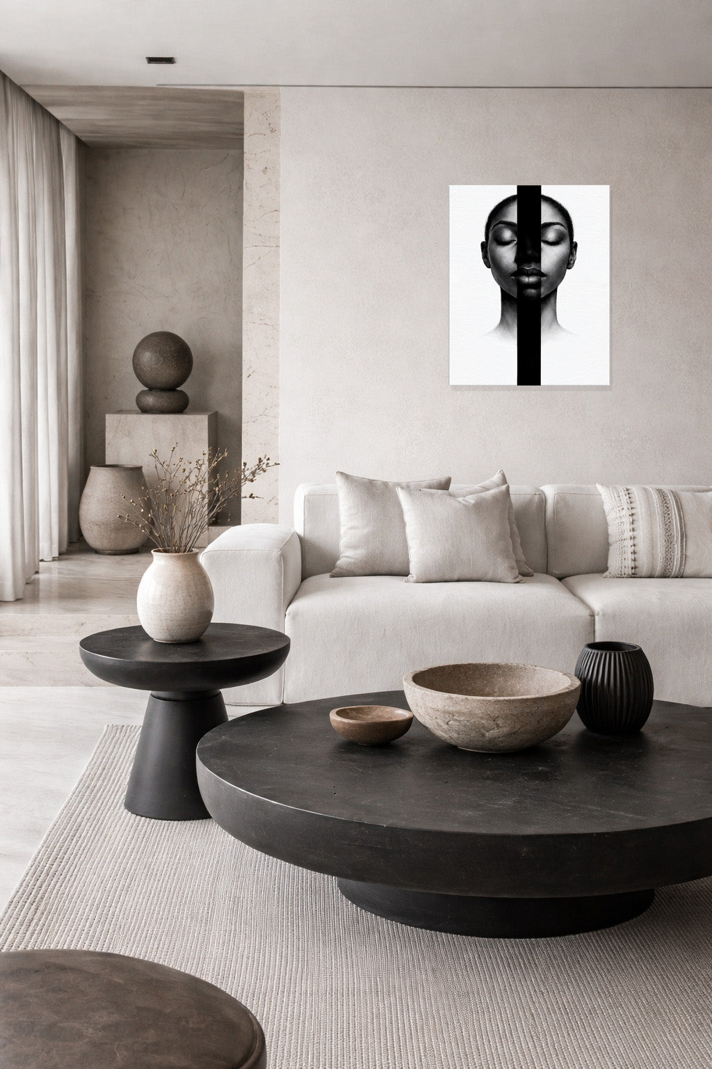 Neutral living room interior styled with black and white portrait wall art