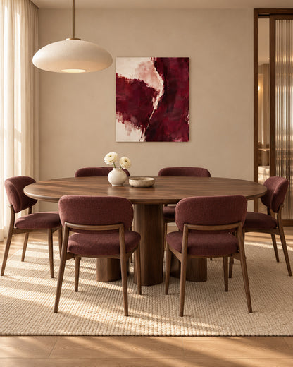 Burgundy Gesture abstract canvas above a wooden dining table with burgundy upholstered chairs