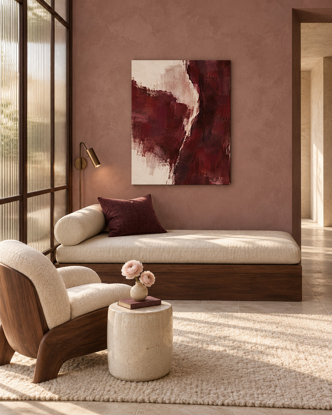 Burgundy Gesture abstract canvas above a cream sofa against a muted pink wall in a sunlit living room