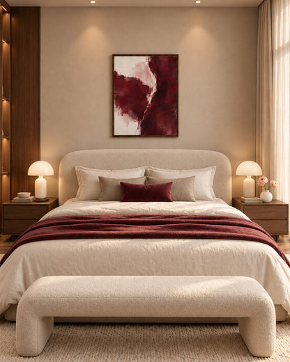 Burgundy Gesture framed abstract canvas above a cream upholstered bed with a burgundy throw