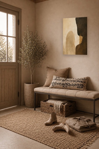 Warm minimalist entryway interior featuring earth tone abstract poster and beige decor accents.