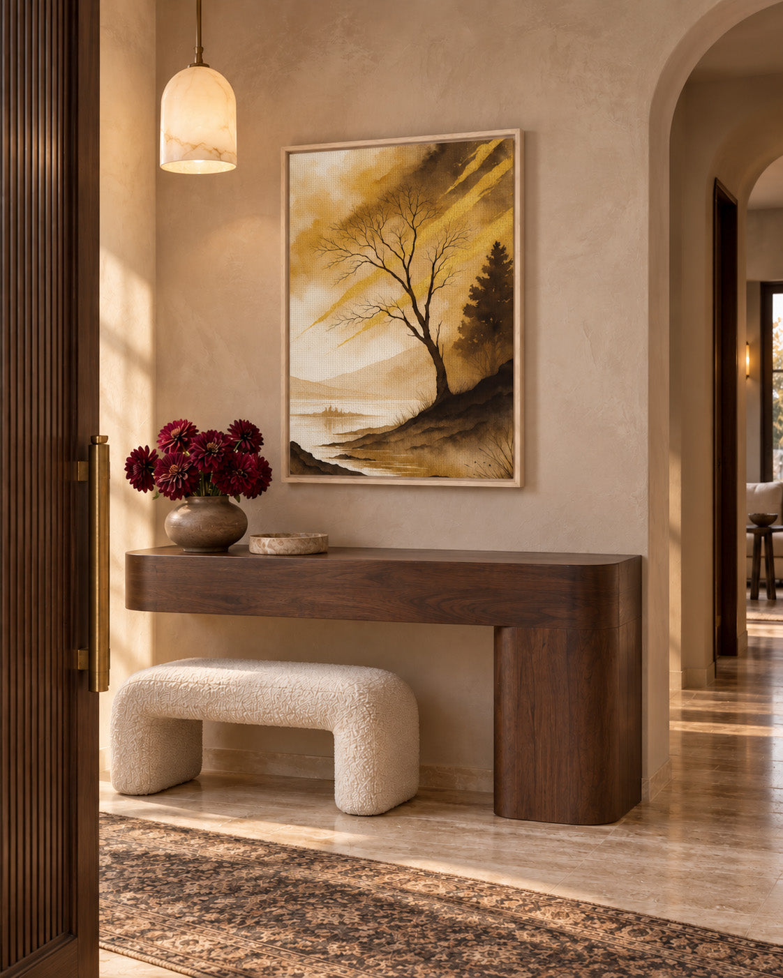 Earthy golden landscape wall art styled in an elegant neutral entryway