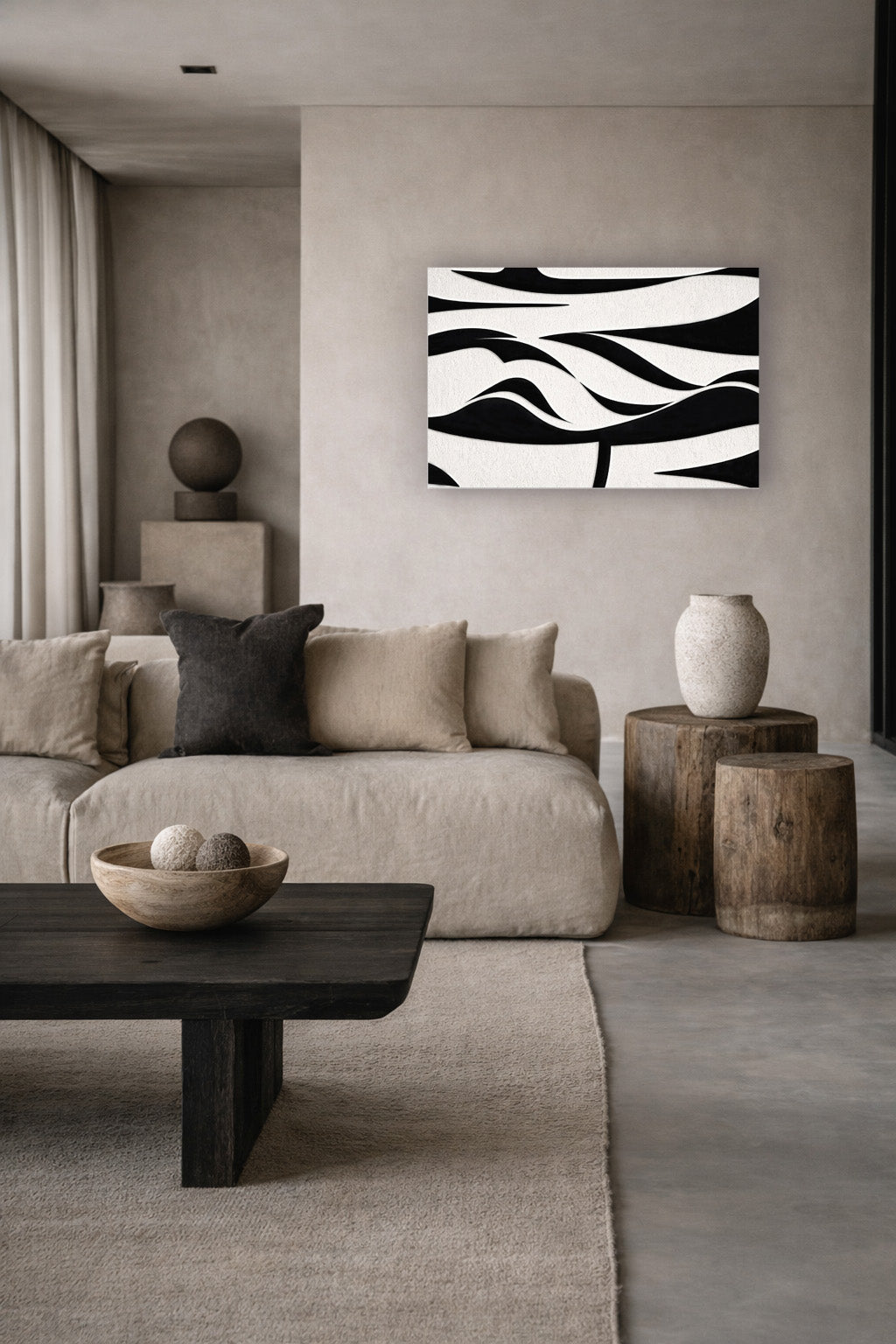 Black and white abstract wall art poster in a minimalist living room with beige decor and natural daylight