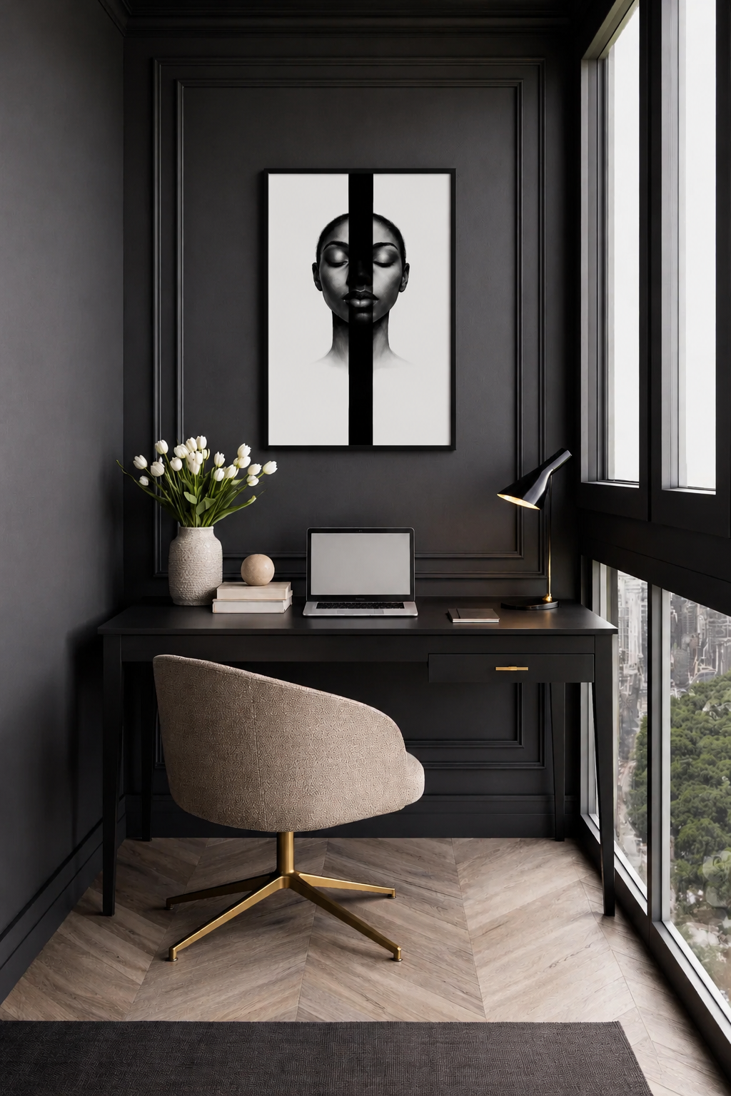 Modern home office with dark paneled walls, beige swivel chair, desk lamp and monochrome portrait artwork displayed above the workspace.
