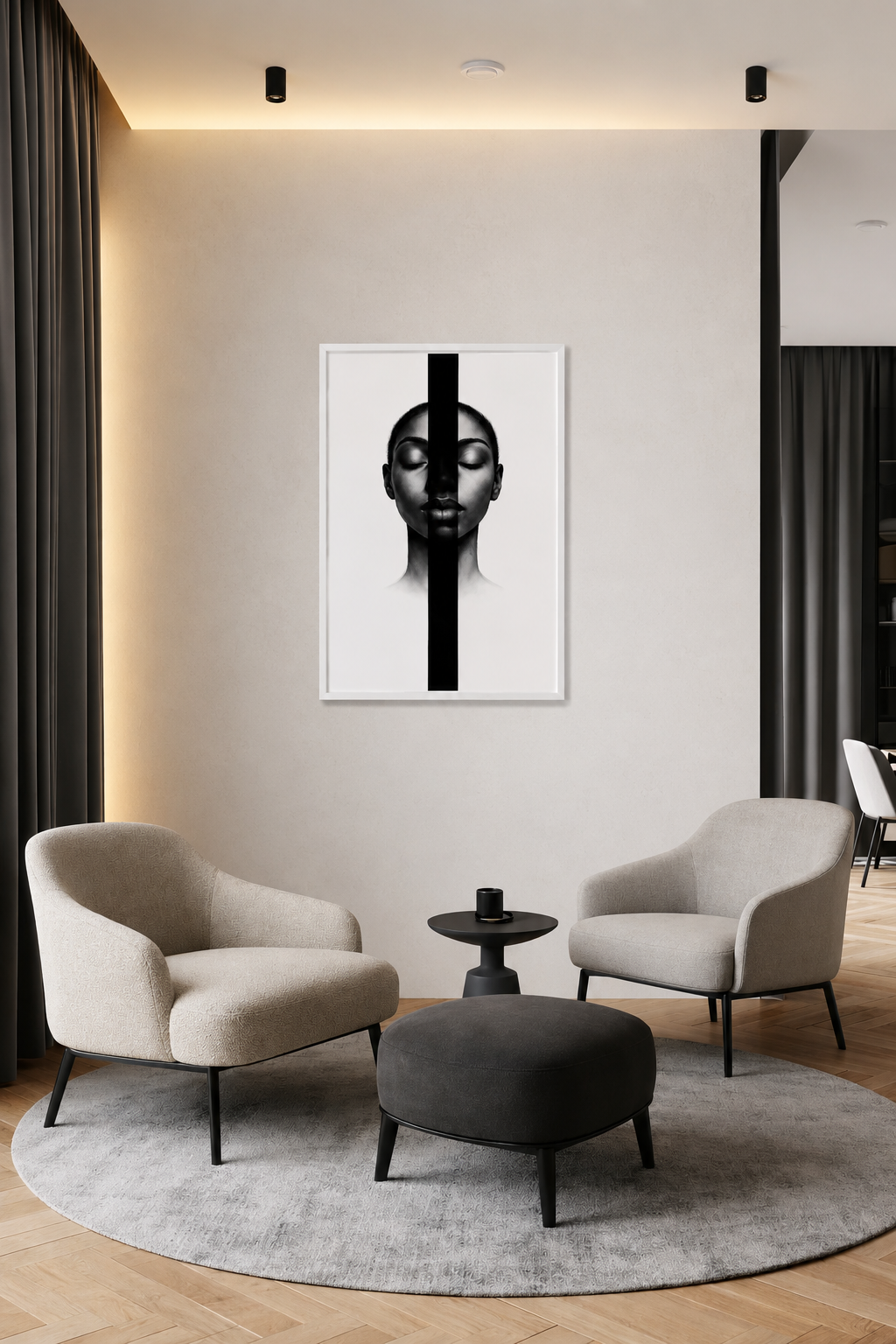 Scandinavian sitting area featuring two cream accent chairs, round rug and abstract black-and-white portrait in a white wooden frame on a neutral wall.