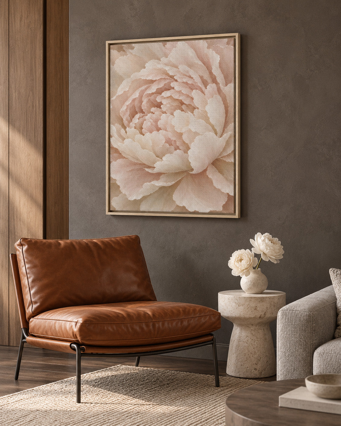 Framed Ivory Peony canvas above a cognac leather lounge chair in a warm neutral living room