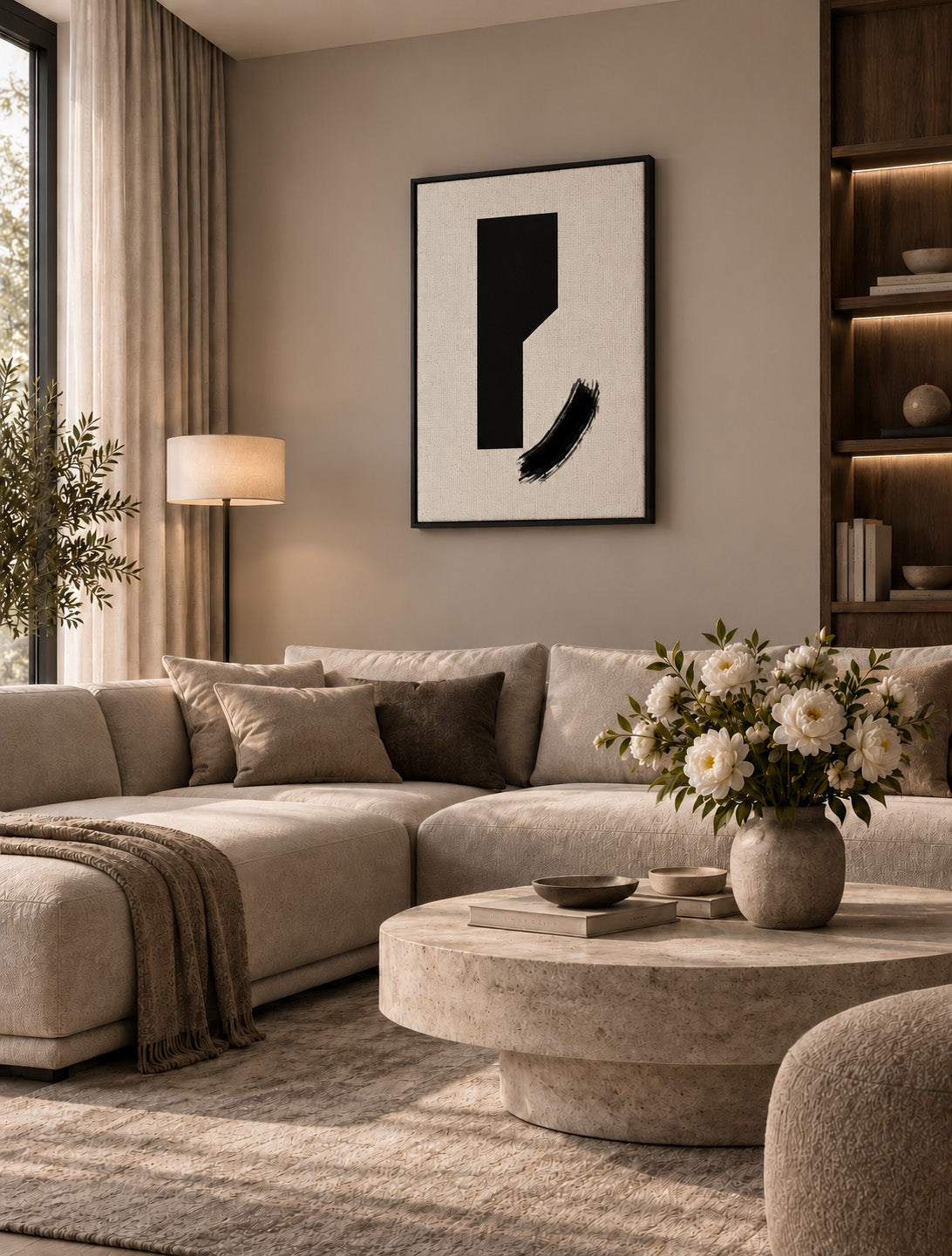 Minimal black abstract artwork displayed in a warm contemporary living room