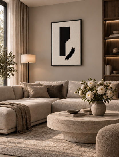 Minimal black abstract artwork displayed in a warm contemporary living room