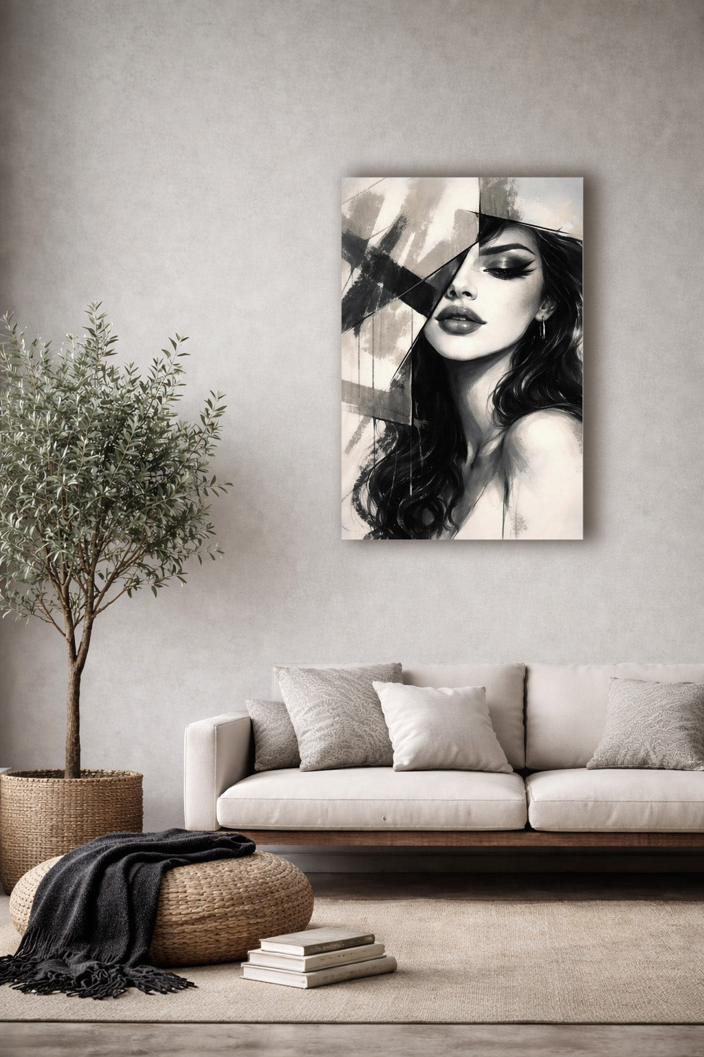 Minimalist living room with beige sofa and natural decor featuring a black and white woman portrait poster on a light textured wall.