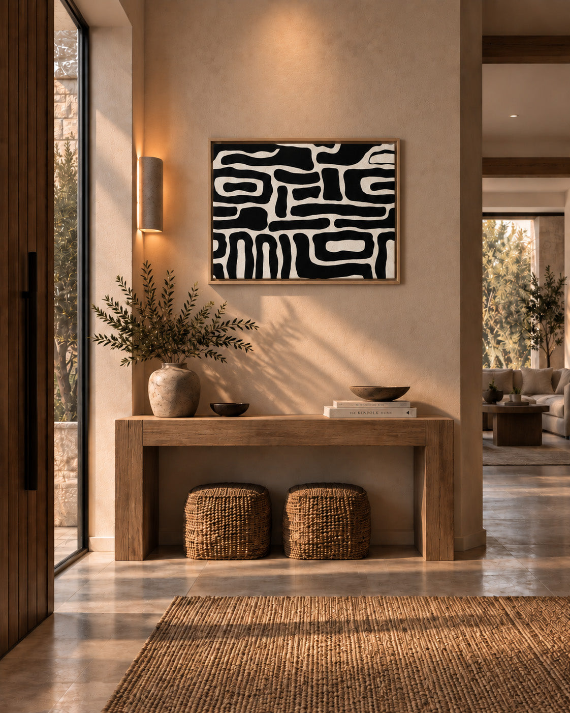 Modern black and white abstract art styled in an elegant contemporary entryway