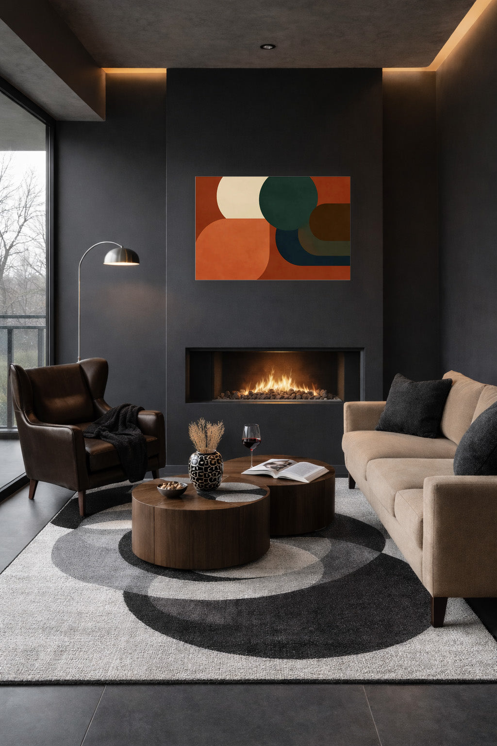 Modern abstract wall art poster displayed above a fireplace in a dark contemporary living room with neutral furniture and warm lighting