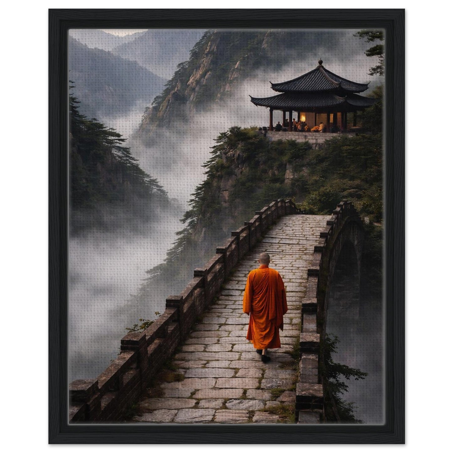 Monk walking through misty mountains wall art in a black floating canvas frame