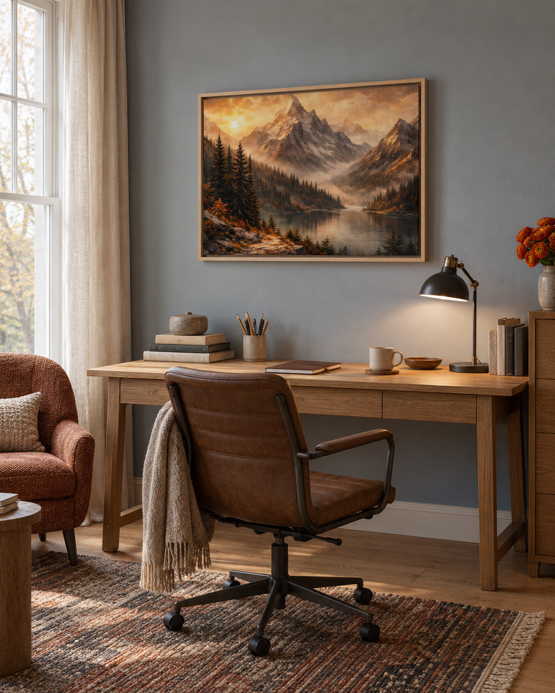 Mountain lake artwork with golden sky displayed in a sophisticated modern home office