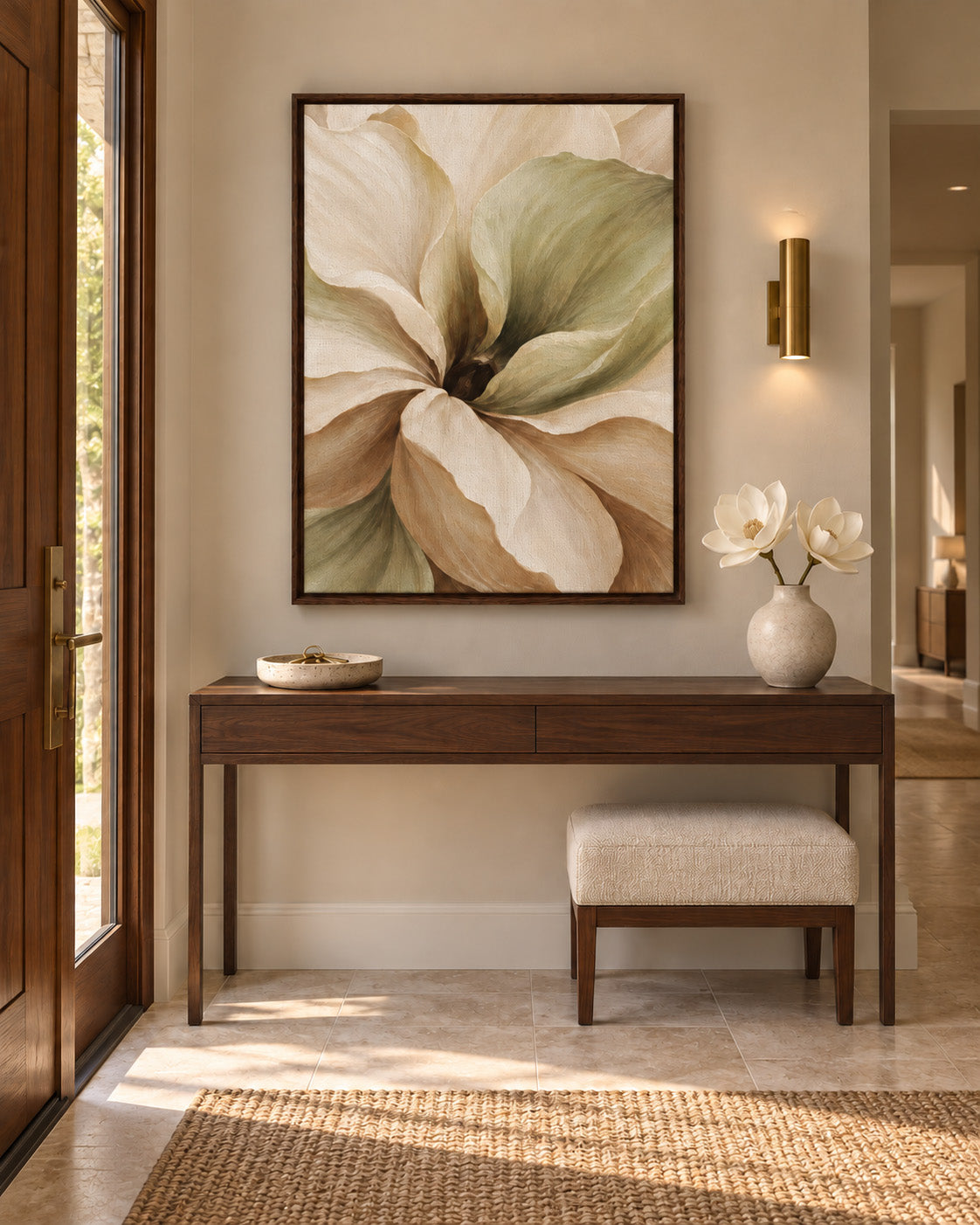 Muted Magnolia canvas in a dark wood frame above a wooden entryway console with a cream stool and white flowers.