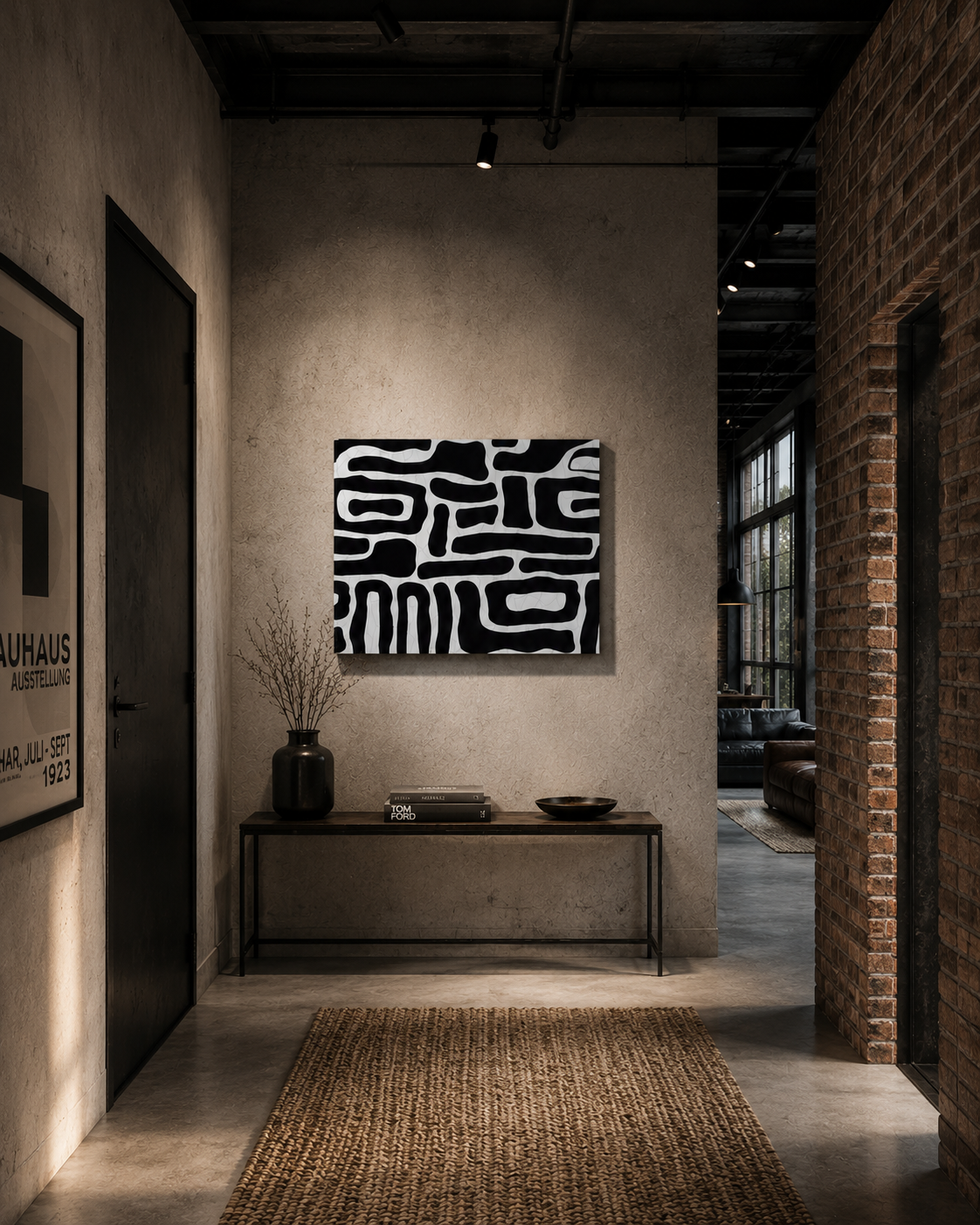 Black and white abstract canvas wall art in a modern industrial loft hallway with a console table and textured decor