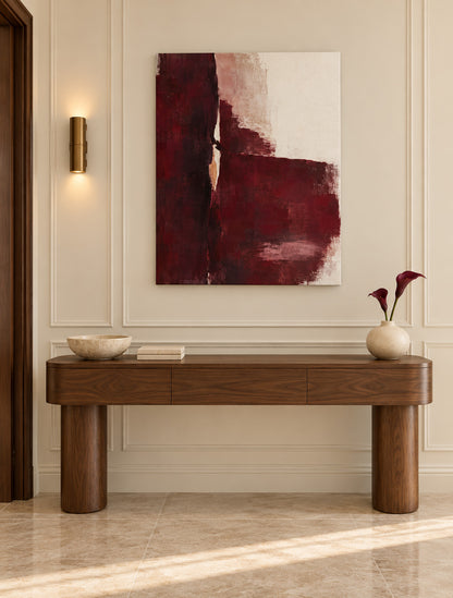 Oxblood Poise burgundy abstract canvas above a wooden console in a paneled hallway