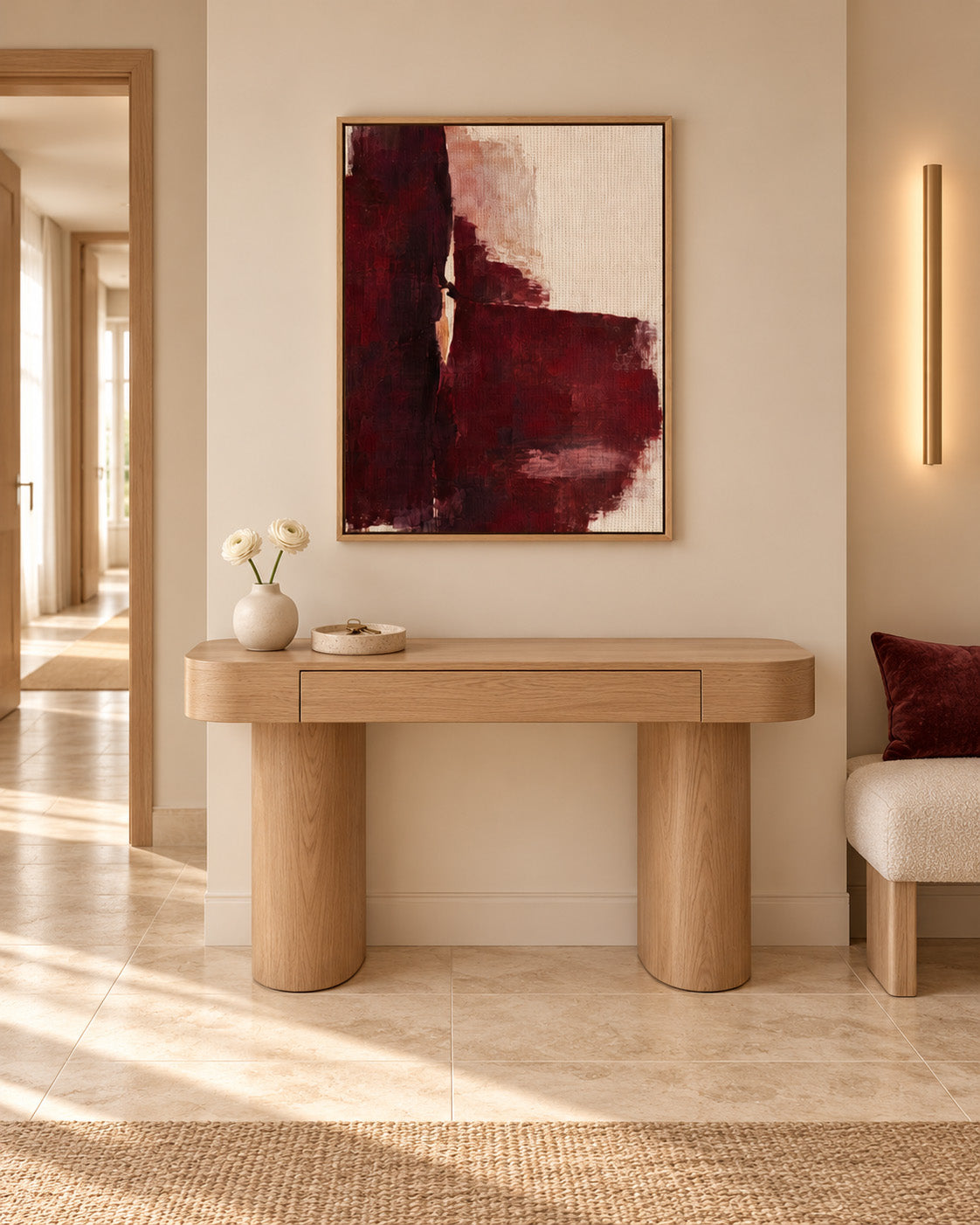 Oxblood Poise burgundy abstract canvas in a light wood frame above a wooden hallway console