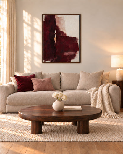 Oxblood Poise framed burgundy abstract canvas above a cream sofa with burgundy cushions in a sunlit living room