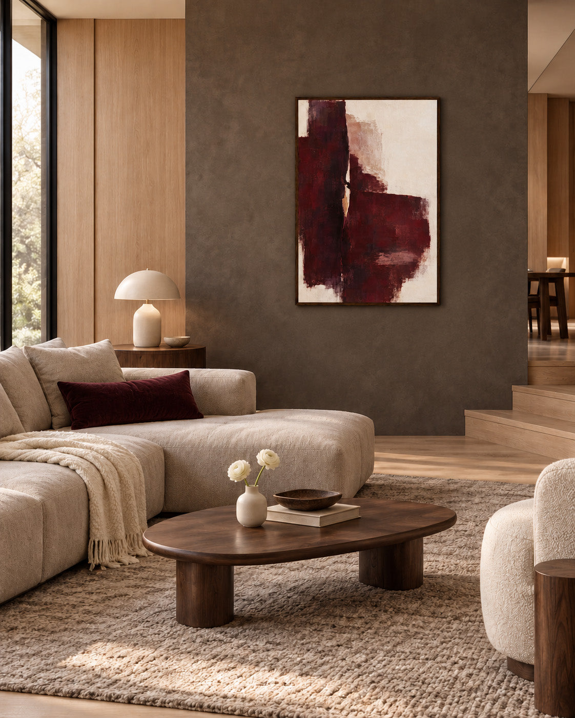Oxblood Poise framed burgundy abstract poster on a taupe wall in a living room with cream seating and a wooden coffee table