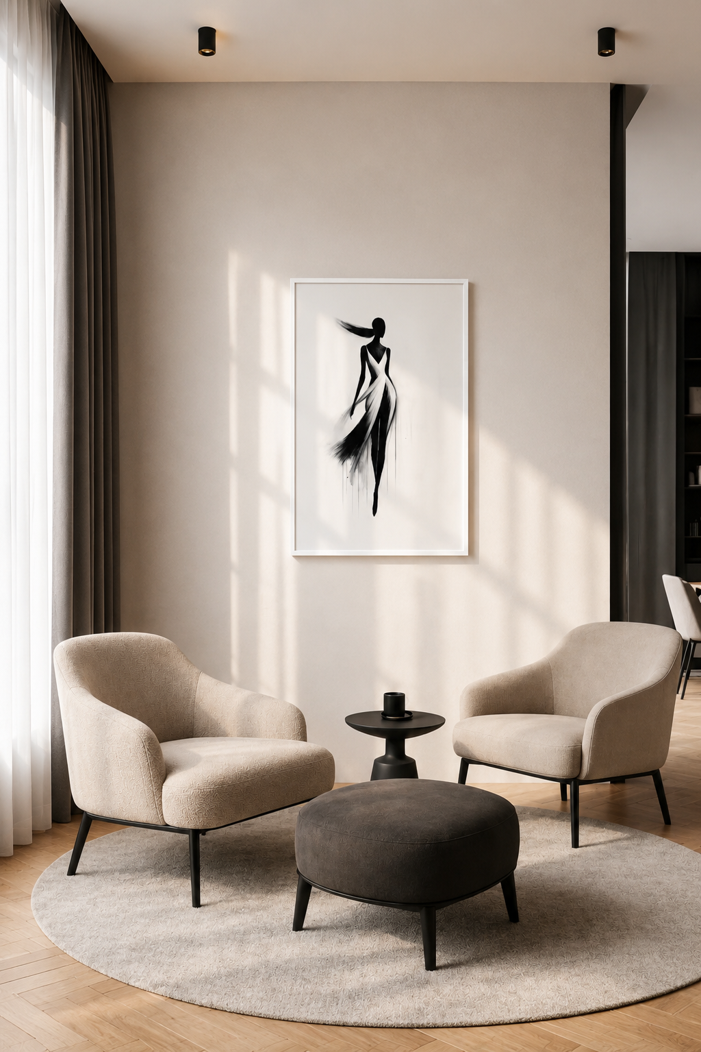 Elegant black and white fashion wall art with a white wooden frame displayed above a cozy seating area with beige armchairs, a round rug, and warm natural daylight.
