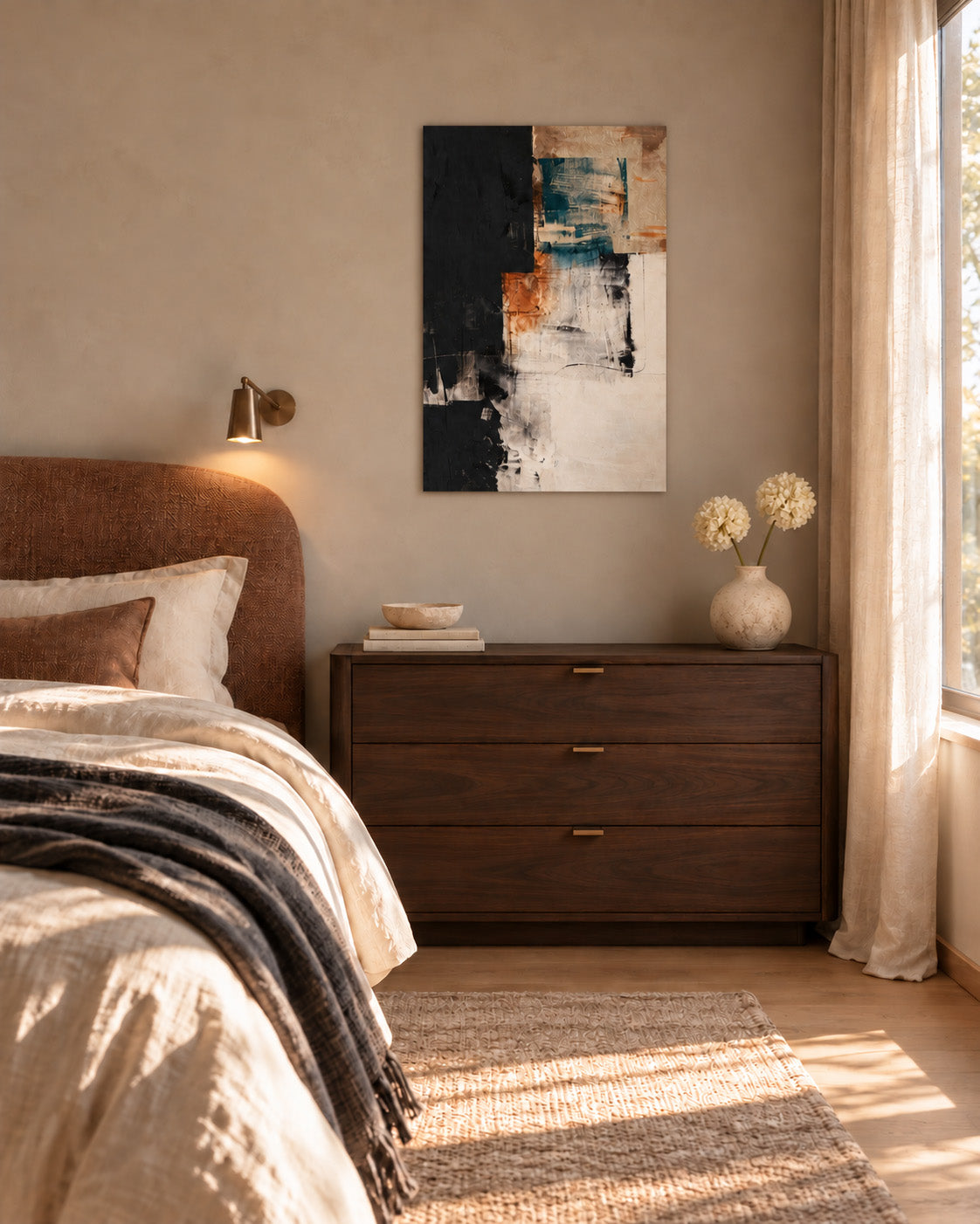 Teal and terracotta abstract poster above a dark wood dresser beside a leather bed in a warm bedroom