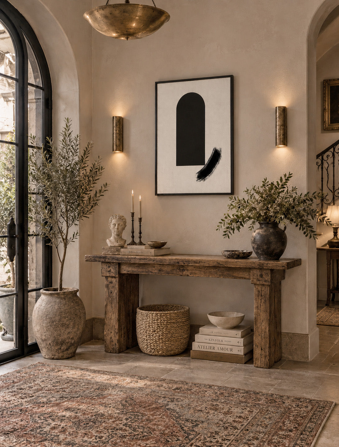Zen inspired black brushstroke artwork styled in a calm modern entryway